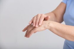 woman putting cream on her hand