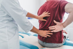 pain management specialist examining the spine